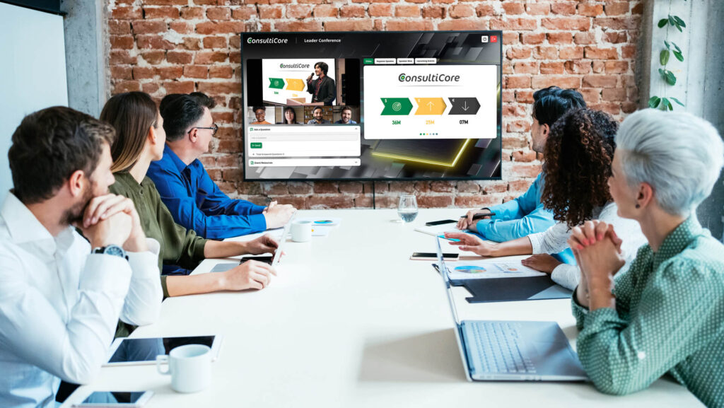 Group of professionals listening in on an event in a boardroom.