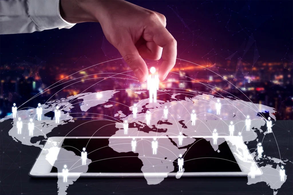 An image of a map with graphic 'people' figures overlayed. The central figure is glowing red with a large hand reaching down from the top of the frame to pick it up with forefinger and thumb