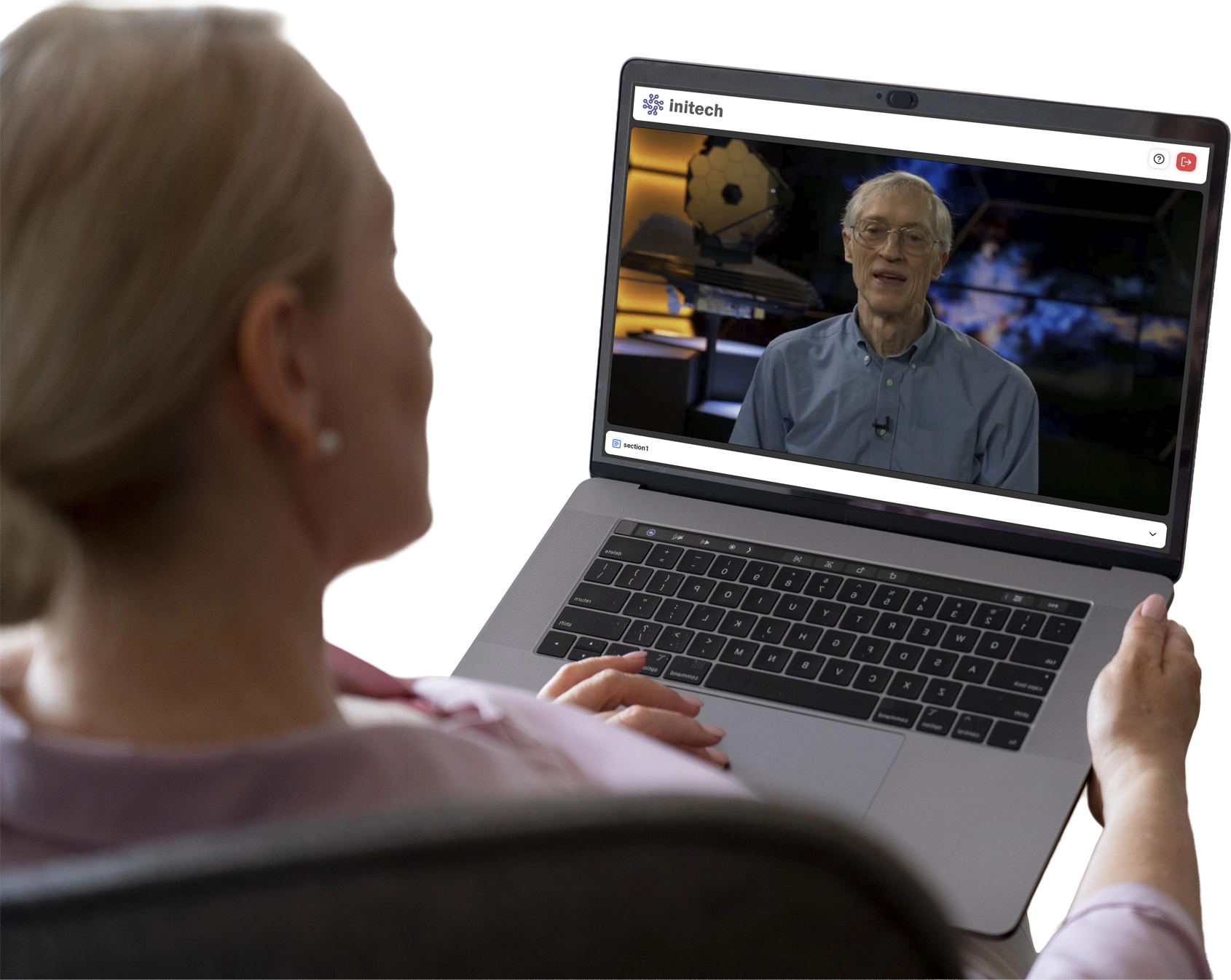A woman sitting at a computer watching a crisis communications broadcast
