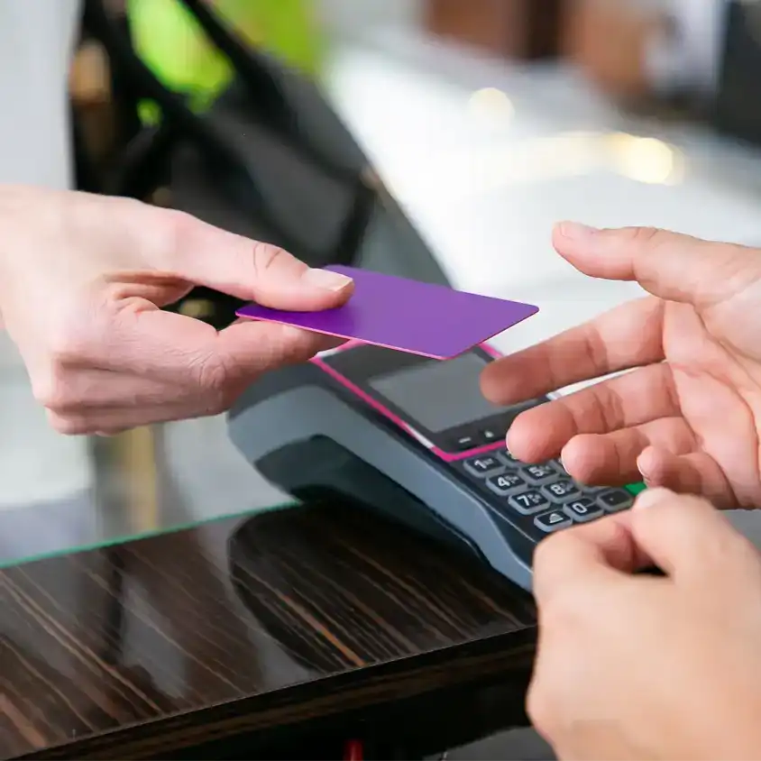 image of a clerk handing a customer back their credit card representing using the globalmeet virtual events platform for retail and hospitality