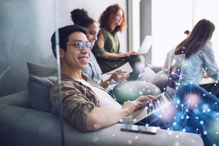 A smiling work team sitting in a casual office