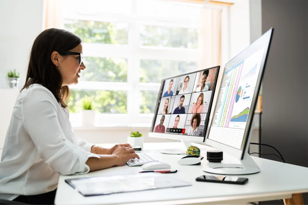 A woman sitting at a bright desk presenting a storytelling driven webcast with GlobalMeet