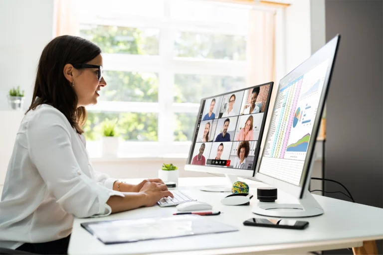 A woman sitting at a bright desk presenting a storytelling driven webcast with GlobalMeet