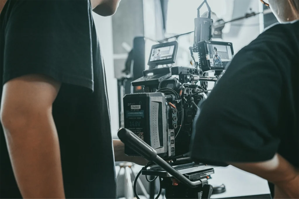 A behind the scenes picture of a camera crew recording a broadcast