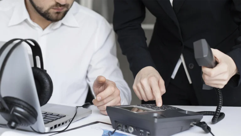 A wide shot of two expert call operators working to facilitate a GlobalMeet Conference Call